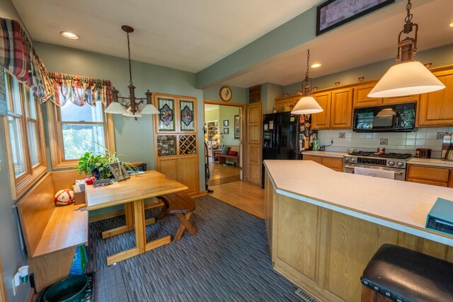 3720 County Highway Nn, West Bend, WI 53095 - kitchen featuring light countertops, recessed lighting, decorative backsplash, hanging light fixtures, and black appliances