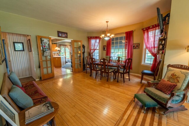 3720 County Highway Nn, West Bend, WI 53095 - dining area with a wealth of natural light, light wood-type flooring, french doors, and an inviting chandelier