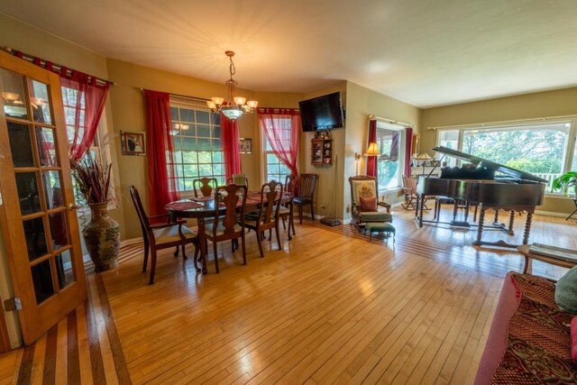 3720 County Highway Nn, West Bend, WI 53095 - dining space featuring hardwood / wood-style floors, plenty of natural light, and a notable chandelier