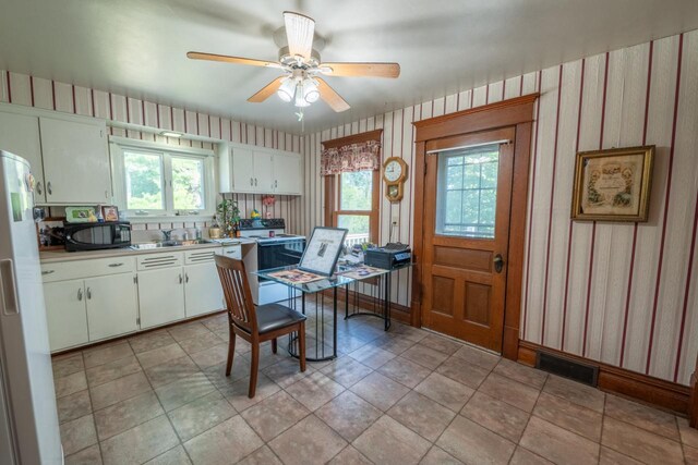 3720 County Highway Nn, West Bend, WI 53095 - kitchen featuring black microwave, wallpapered walls, white refrigerator with ice dispenser, and electric range