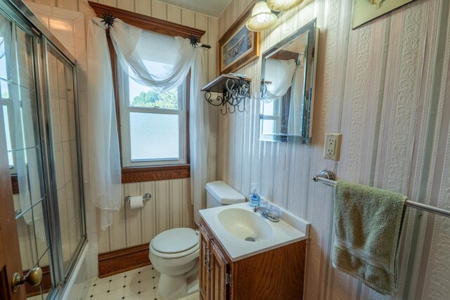 3720 County Highway Nn, West Bend, WI 53095 - full bath featuring tile patterned floors, bath / shower combo with glass door, toilet, and vanity
