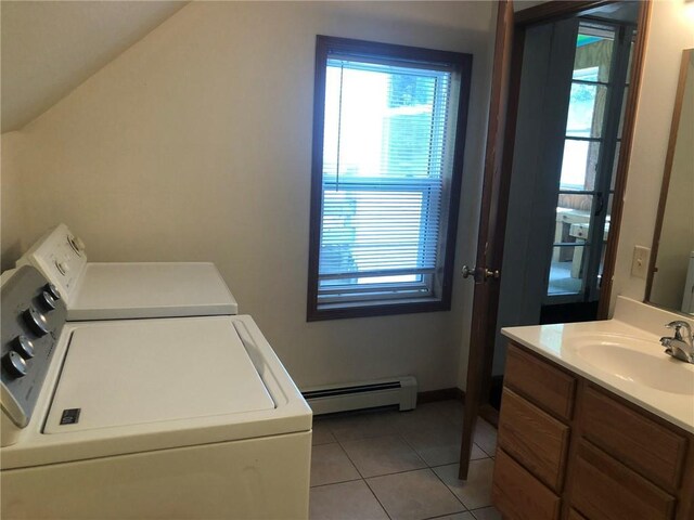 609 S Dewey St, Eau Claire, WI 54701 - washroom with washing machine and clothes dryer, light tile patterned flooring, a sink, laundry area, and baseboard heating
