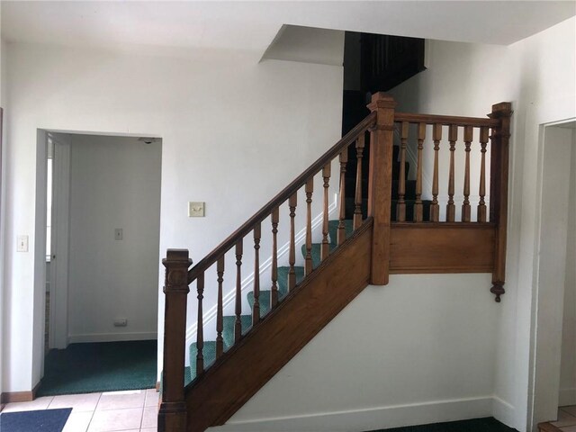 609 S Dewey St, Eau Claire, WI 54701 - stairway with baseboards and tile patterned floors