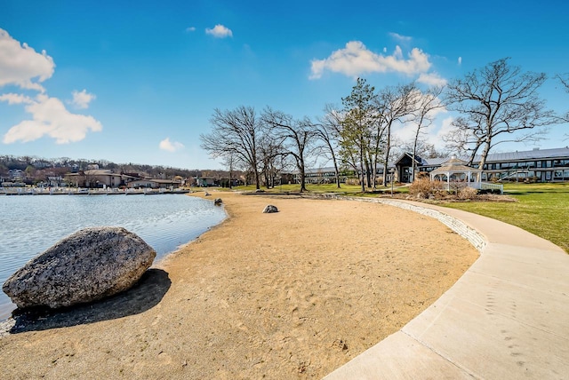 surrounding community with a lawn and a water view