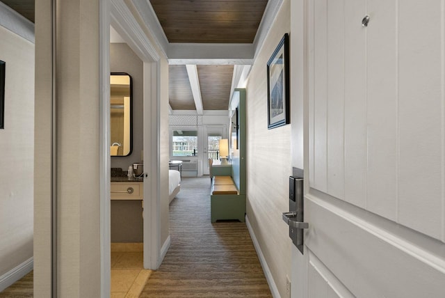 hallway featuring wooden ceiling and baseboards