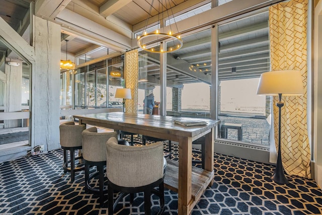 dining area featuring a chandelier and wooden ceiling