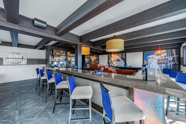 bar with beamed ceiling and wooden walls