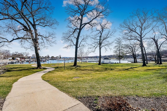 view of home's community featuring a water view and a yard