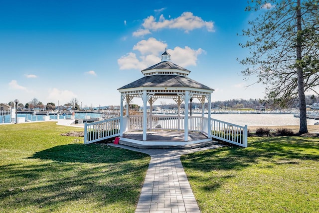 view of property's community with a yard, a gazebo, and a water view
