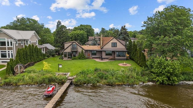 2346 Hickory Ln, Oshkosh, WI 54901 - back of house with an outdoor fire pit, a patio, a water view, and a lawn