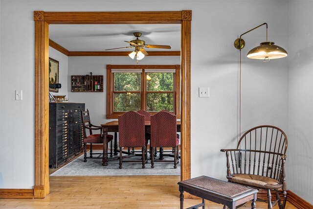 2346 Hickory Ln, Oshkosh, WI 54901 - dining space with baseboards, crown molding, a ceiling fan, and wood-type flooring