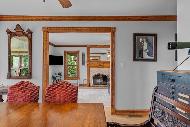2346 Hickory Ln, Oshkosh, WI 54901 - dining area with crown molding, a ceiling fan, a fireplace, wood finished floors, and visible vents