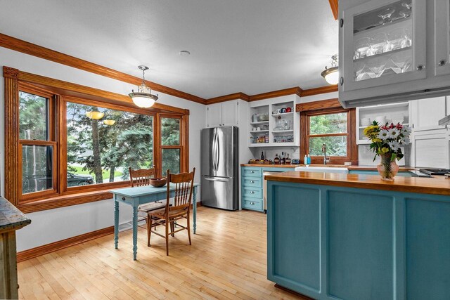 2346 Hickory Ln, Oshkosh, WI 54901 - kitchen with a sink, open shelves, butcher block counters, stainless steel appliances, and ornamental molding