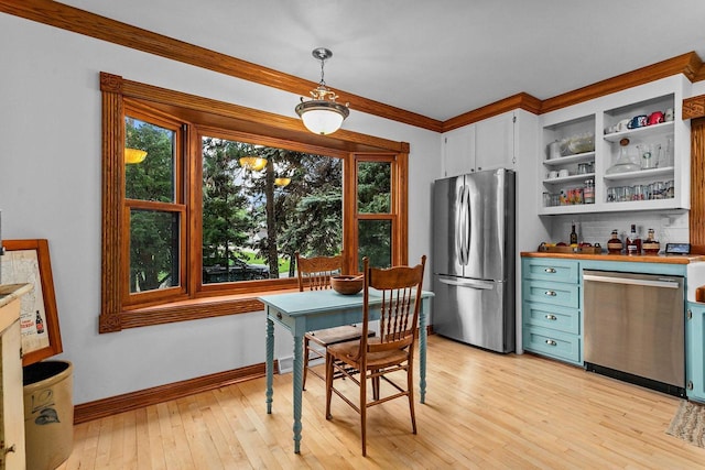 2346 Hickory Ln, Oshkosh, WI 54901 - dining room featuring light wood-style flooring, ornamental molding, and baseboards