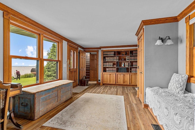 2346 Hickory Ln, Oshkosh, WI 54901 - living area featuring visible vents, ornamental molding, and light wood-style flooring
