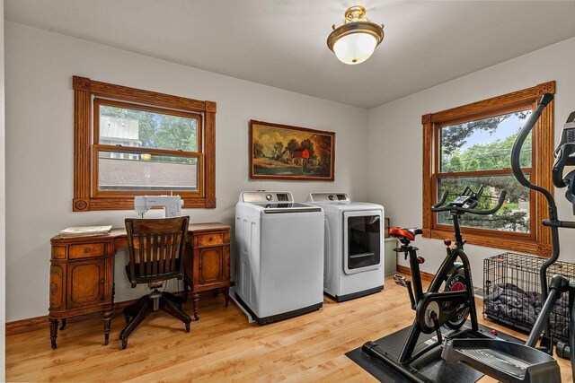 2346 Hickory Ln, Oshkosh, WI 54901 - laundry room with washer and clothes dryer, light wood-type flooring, laundry area, and baseboards