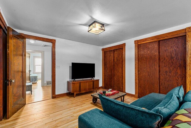 2346 Hickory Ln, Oshkosh, WI 54901 - living area with visible vents, baseboards, and light wood-type flooring