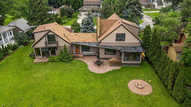 2346 Hickory Ln, Oshkosh, WI 54901 - rear view of house featuring a chimney, a lawn, a residential view, and a patio area