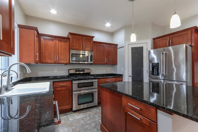 1579 Foxfire Ct, Waupaca, WI 54981 - kitchen with hanging light fixtures, a sink, recessed lighting, dark stone counters, and stainless steel appliances