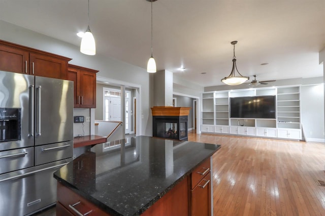 1579 Foxfire Ct, Waupaca, WI 54981 - kitchen featuring light wood-type flooring, ceiling fan, pendant lighting, and high quality fridge