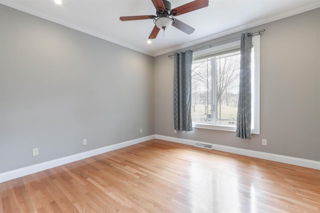 1579 Foxfire Ct, Waupaca, WI 54981 - empty room featuring light wood-style flooring, crown molding, baseboards, and visible vents