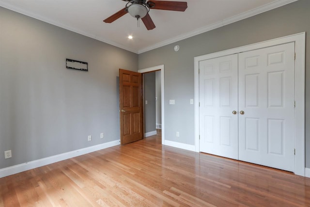 1579 Foxfire Ct, Waupaca, WI 54981 - unfurnished bedroom featuring a closet, baseboards, crown molding, ceiling fan, and light wood finished floors
