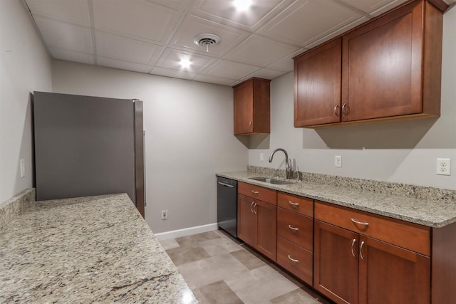 1579 Foxfire Ct, Waupaca, WI 54981 - kitchen featuring baseboards, dishwasher, a sink, freestanding refrigerator, and light stone counters