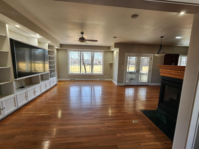 1579 Foxfire Ct, Waupaca, WI 54981 - unfurnished living room featuring dark wood-type flooring, built in features, baseboards, and a ceiling fan