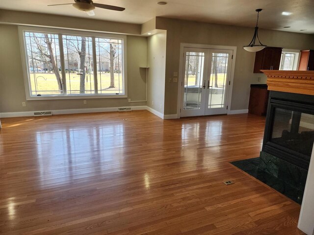 1579 Foxfire Ct, Waupaca, WI 54981 - unfurnished living room featuring visible vents, ceiling fan, baseboards, and wood finished floors