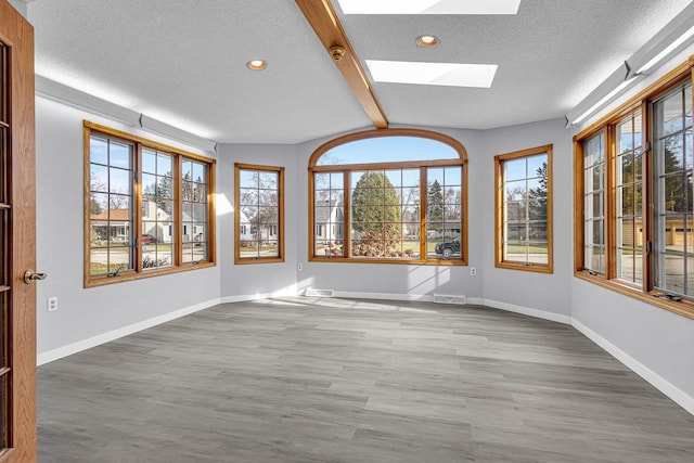 unfurnished room with recessed lighting, baseboards, a textured ceiling, visible vents, and wood finished floors