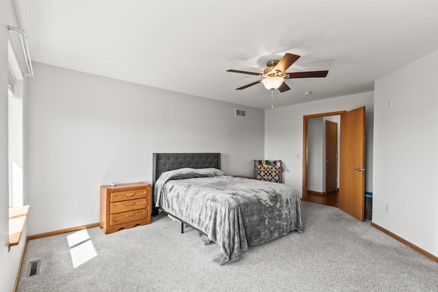 carpeted bedroom featuring ceiling fan, baseboards, and visible vents
