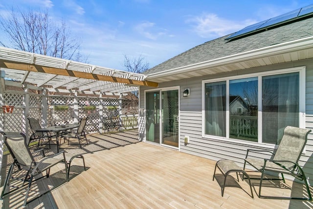 deck featuring outdoor dining space and a pergola