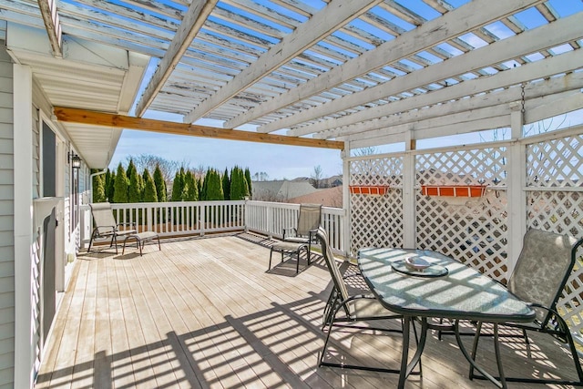 wooden terrace featuring outdoor dining area and a pergola