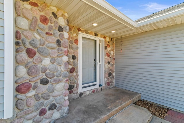 doorway to property featuring stone siding