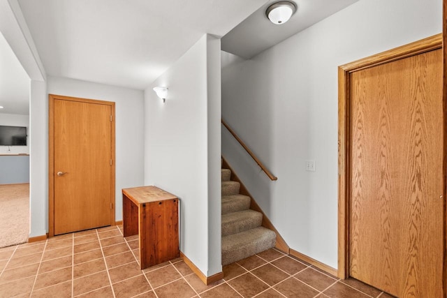 stairway featuring tile patterned flooring