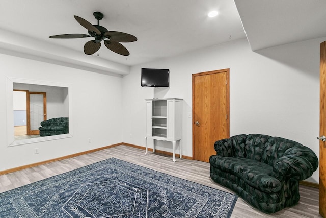 sitting room with wood finished floors, baseboards, a ceiling fan, and recessed lighting