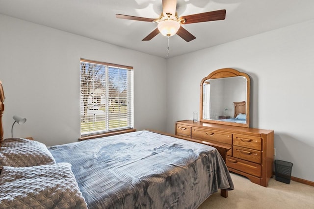 bedroom featuring light carpet, baseboards, and a ceiling fan