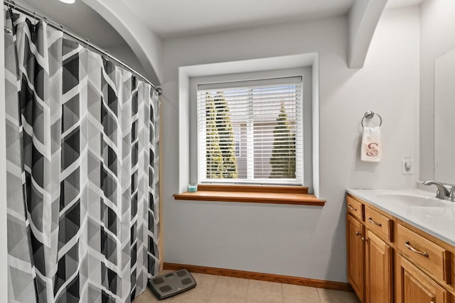 full bath featuring tile patterned floors, vanity, baseboards, and a shower with curtain