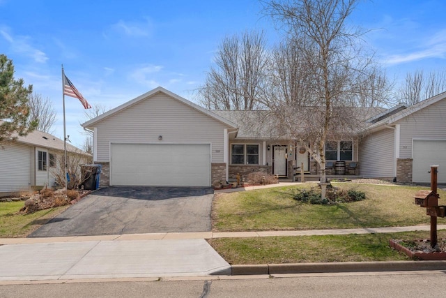 509 Meadow View Rd, Mount Horeb, WI 53572 - ranch-style home featuring an attached garage, aphalt driveway, a front yard, and brick siding