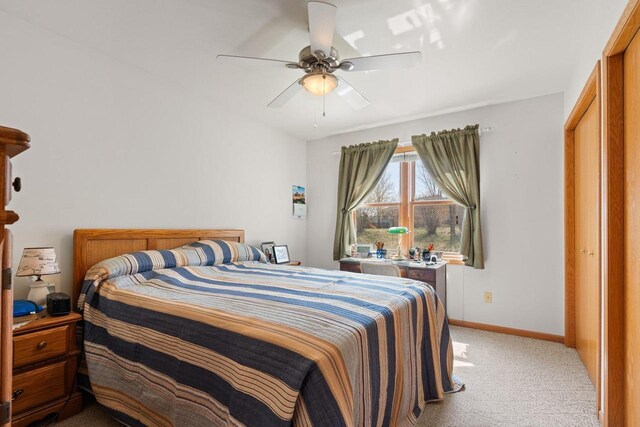 509 Meadow View Rd, Mount Horeb, WI 53572 - bedroom featuring a closet, light carpet, a ceiling fan, and baseboards