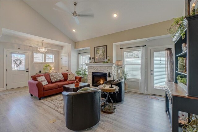 102 Linden Ave, Hudson, WI 54016 - living room featuring recessed lighting, a stone fireplace, ceiling fan with notable chandelier, and light wood-type flooring