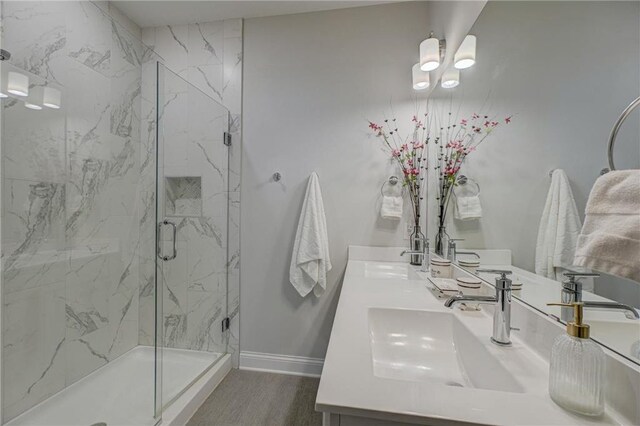 102 Linden Ave, Hudson, WI 54016 - full bathroom with baseboards, wood finished floors, a sink, and a marble finish shower