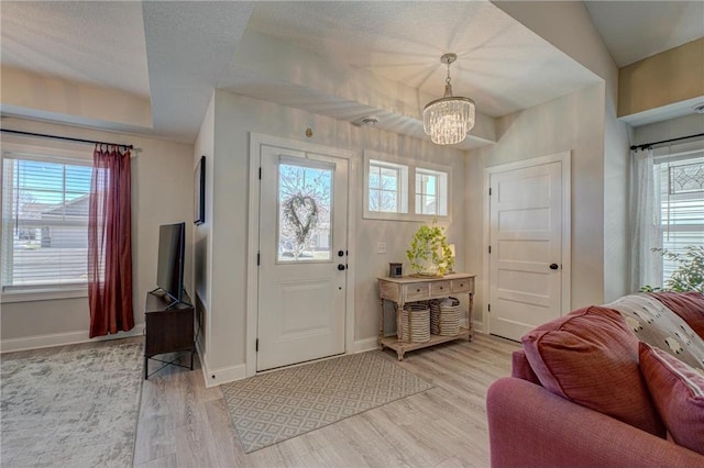 102 Linden Ave, Hudson, WI 54016 - foyer entrance featuring light wood finished floors, baseboards, and a chandelier