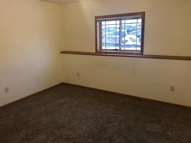 carpeted empty room with baseboards