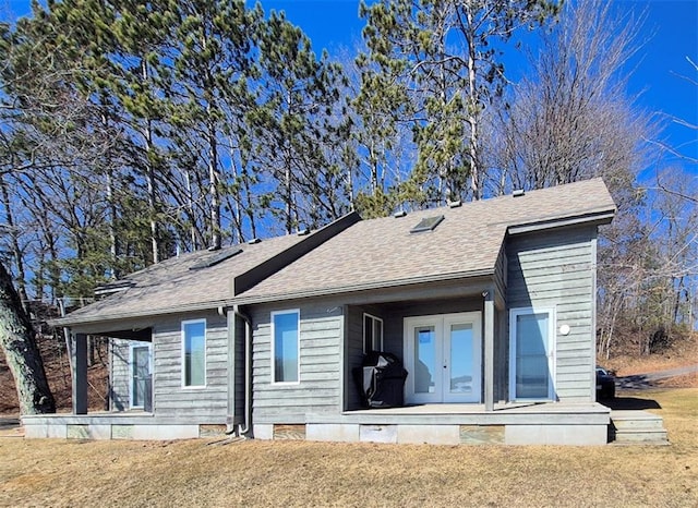 7744 Otte Dr Unit 1, Hayward, WI 54843 - back of property featuring french doors and a shingled roof