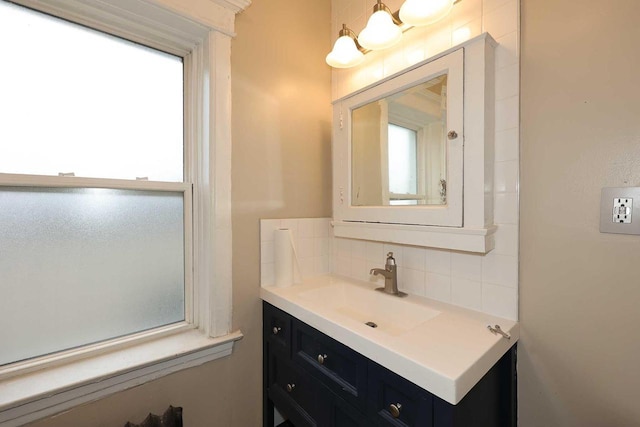 bathroom with decorative backsplash and vanity
