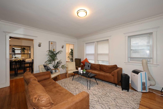 living room with ornamental molding and wood finished floors