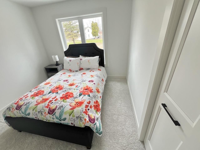 carpeted bedroom featuring baseboards