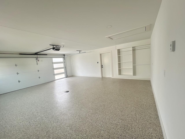 garage with baseboards and a garage door opener