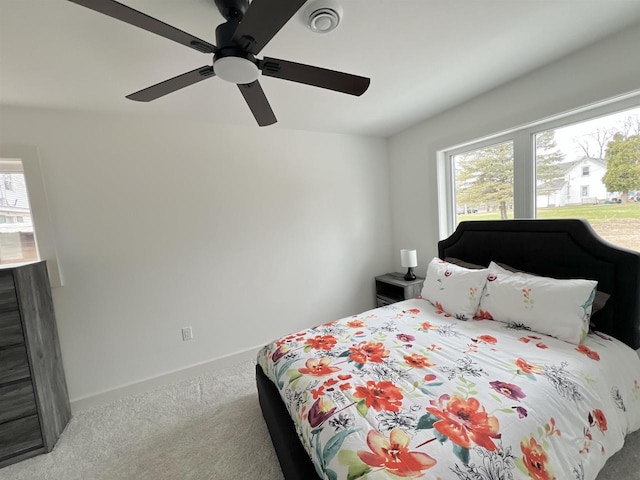 carpeted bedroom featuring visible vents, baseboards, and a ceiling fan